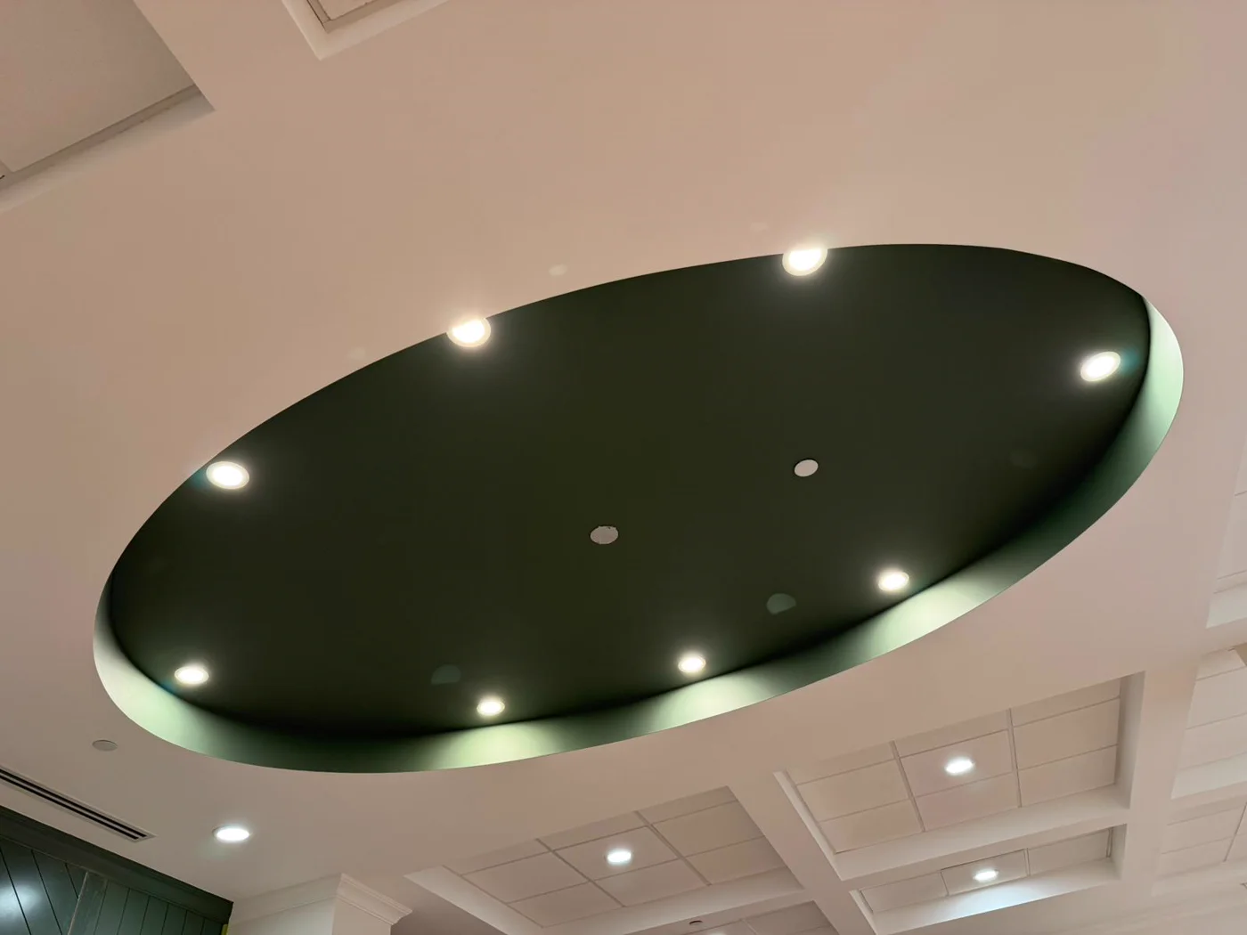 Deep green oval tray ceiling with recessed lights